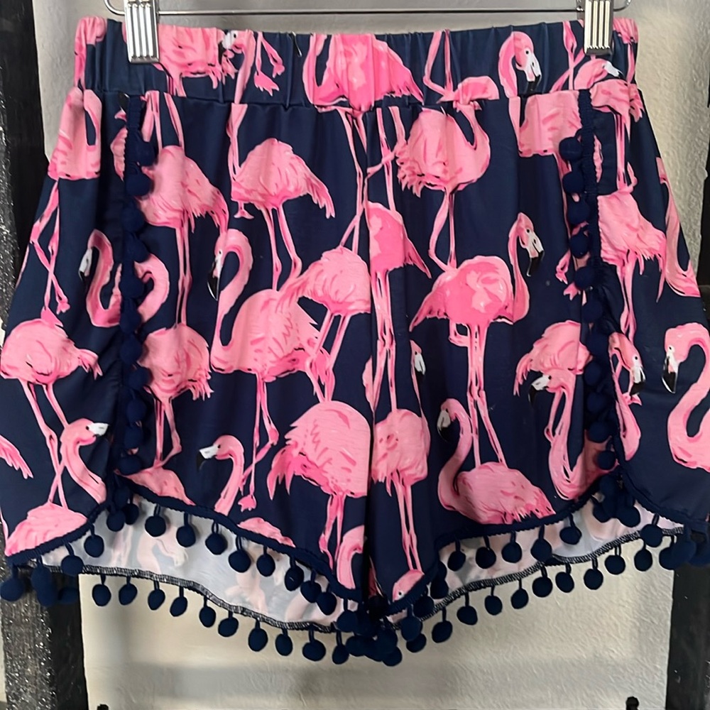 Cute elastic flamingo shorts with pompoms around the bottom.